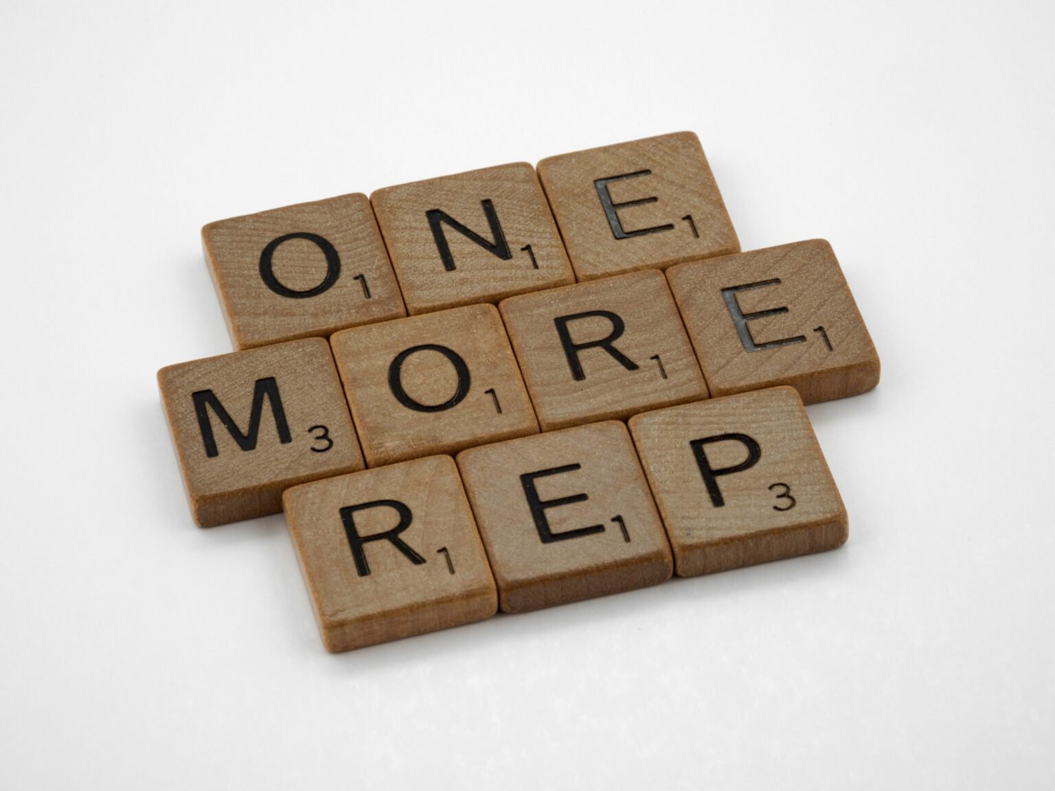 scrabble pieces spelling out one more rep